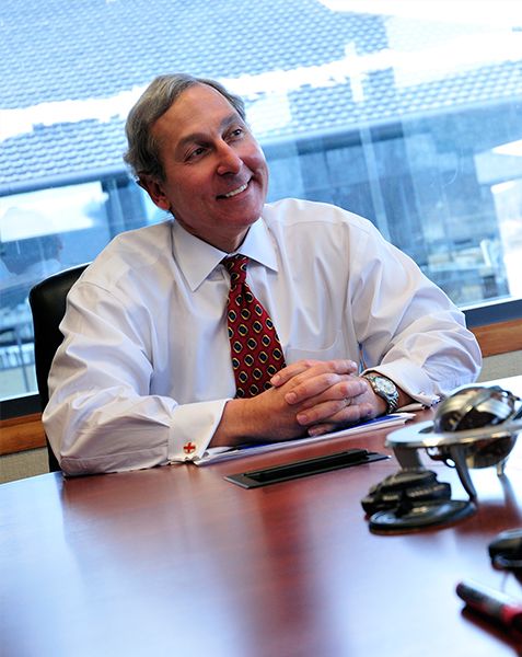 Peter F. Volanakis, retired President and COO of Corning Incorporated, photographed in conversation.
