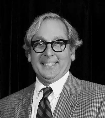 Peter Volanakis at a public address, photographed in black and white.